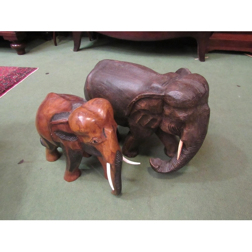 4181 - Two large carved wooden elephants, 30cm and 27cm tall