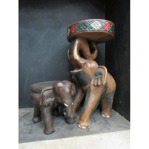 4183 - A carved wooden elephant table, 51cm tall, and a similar example, 21cm tall (2)