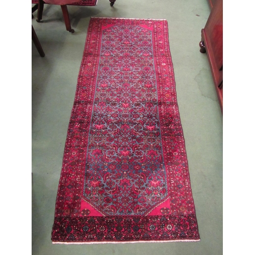 4198 - A Persian blue ground runner rug, allover foliate design, multiple red borders, 200cm x 82cm