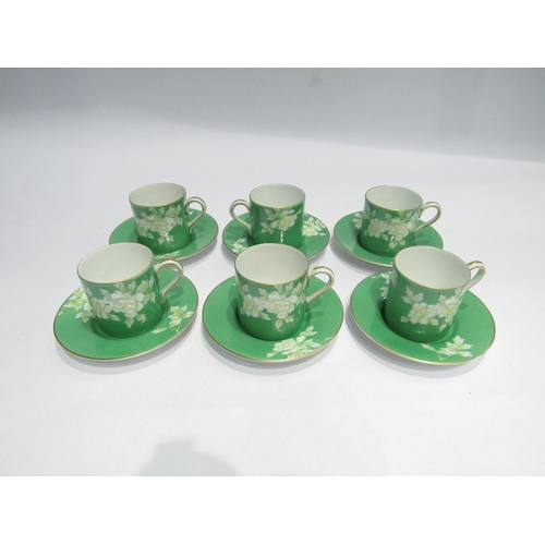 4199 - A Noritake set of six coffee cans and saucers, green ground with floral design, one can a/f