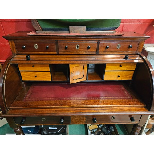 4172 - An early Victorian mahogany roll top desk, the three raised drawers over a tambour front (locking ke... 