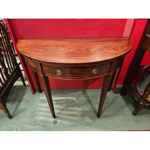 4084 - A George III inlaid flame mahogany bow front side table, the single drawer over square tapering legs... 