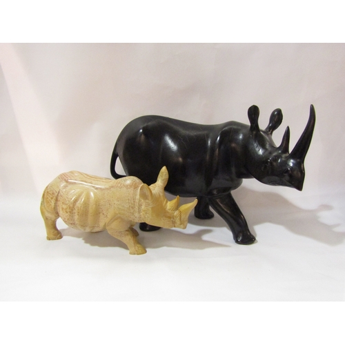 4331 - A large carved wooden rhino, 26.5cm, together with soapstone example, and book ends (3)