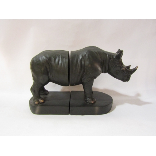 4331 - A large carved wooden rhino, 26.5cm, together with soapstone example, and book ends (3)