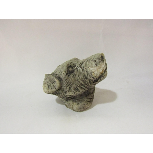 4080 - A stone wall hanging head of a Terrier dog