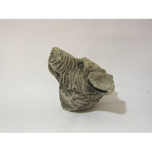 4080 - A stone wall hanging head of a Terrier dog