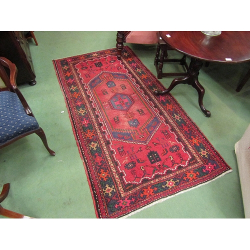 4111 - A Persian Hamadan runner rug, red ground with geometric and animal design, 215cm x 111cm