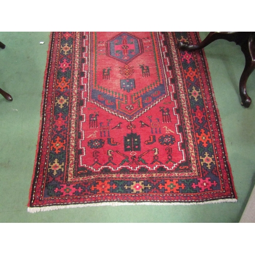 4111 - A Persian Hamadan runner rug, red ground with geometric and animal design, 215cm x 111cm