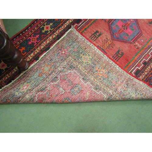 4111 - A Persian Hamadan runner rug, red ground with geometric and animal design, 215cm x 111cm