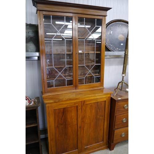 2236 - A hardwood bookcase, twin doors, astragal glazed top over twin cupboard doors