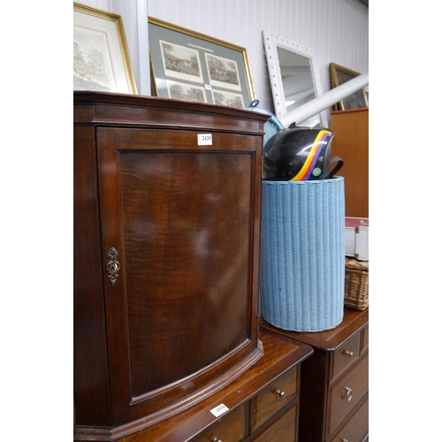 2471 - A mahogany bow fronted wall hanging corner cupboard