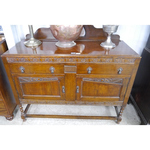 2132 - A 1940's oak sideboard, mirrored gallery back, twin drawers, twin doors, barley twist legs