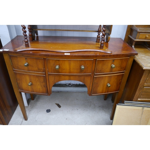 2149 - A Regency style yew wood bow-fronted side table, raised on square tapering legs   (R) £30