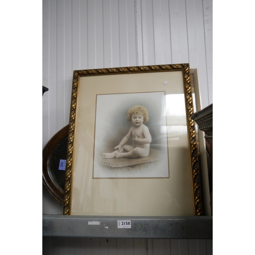 2158 - A handcoloured image of naked child seated on table and a print of pixie and animals, both framed an... 