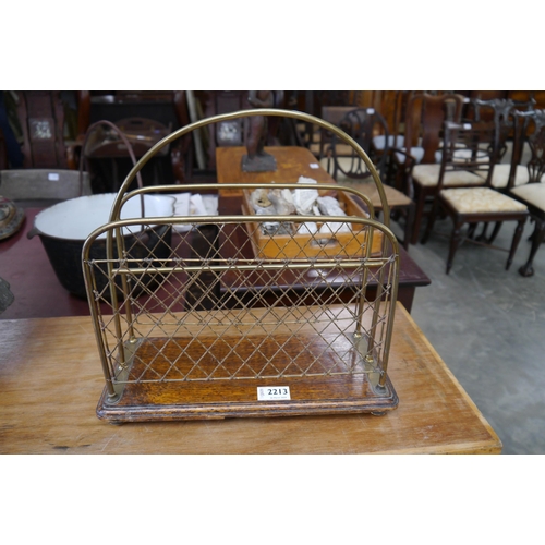 2213 - An Edwardian oak and brass magazine rack