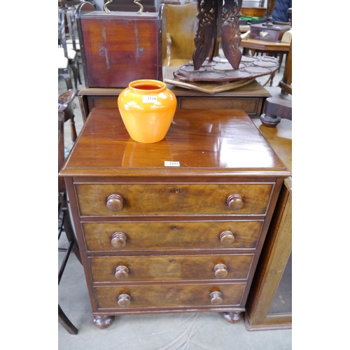 2221 - A Victorian mahogany chest of three drawers, bun handles and feet of small proportions