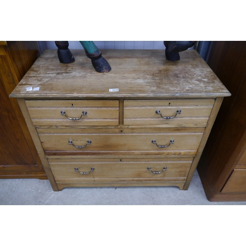 2239 - An early 20th Century oak chest of two short over two long drawers