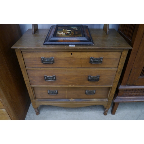 2248 - An Edwardian chest of drawers, three long drawers, turned supports