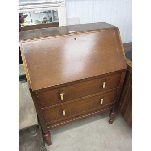 2426 - A 1930's oak bureau, the fall front over two long drawers   (C)