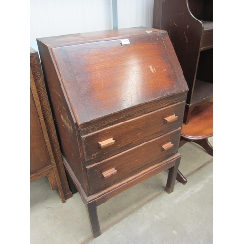 2449 - A 1920's oak bureau, fall front over two long drawers  (R) £0  (E) £8-12