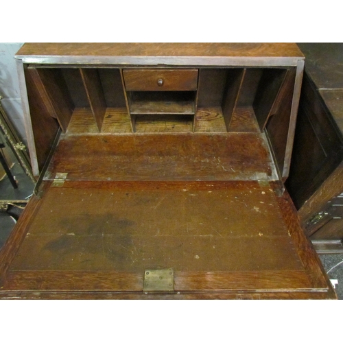 1028 - An early 20th Century oak two drawer bureau on stretcher base, 99cm tall x 80cm wide x 42cm deep