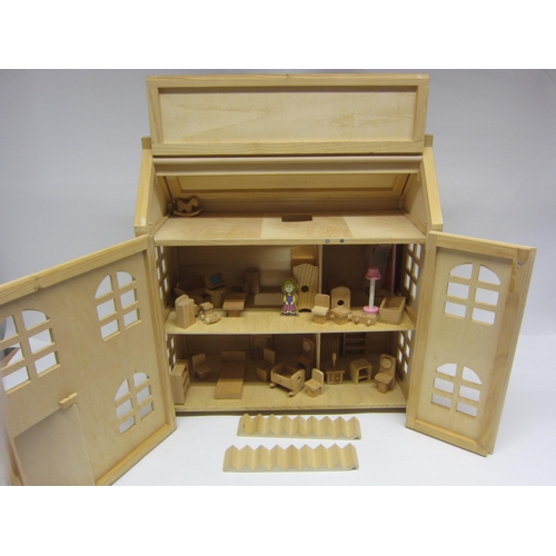 1055 - A two storey wooden dolls house with assorted wooden furniture