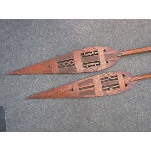 1494 - Two West African carved paddles, pierced geometric design, one a/f, 171cm & 154cm