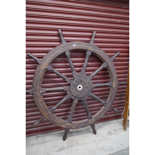 2074 - A large weathered oak and brass inlaid ships wheel 174cm