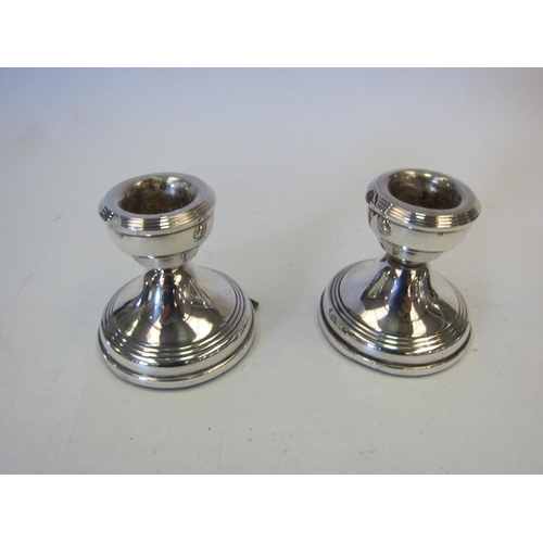 1348 - A pair of W.I. Broadway & Co silver squat form candlesticks, Birmingham 1968, weighted, 5.5cm tall