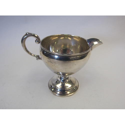 1366 - A silver milk jug marked sterling, 10cm tall    (R)  £50