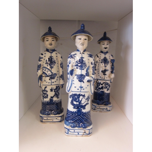 1401 - Three Chinese blue and white figures, 27cm tall