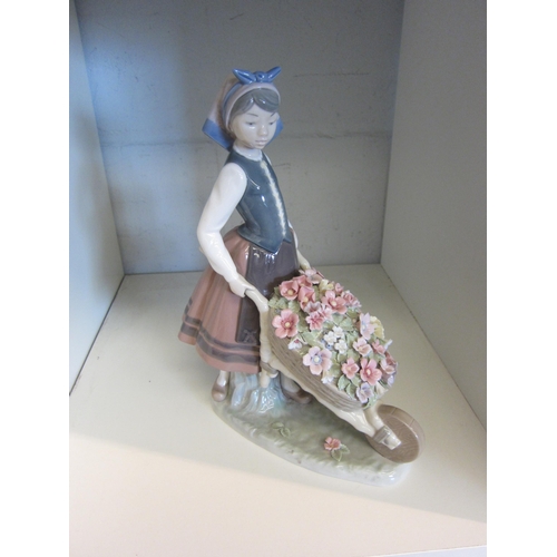 1426 - A Lladro figure of girl holding wheelbarrow of flowers, boxed, 25.5cm tall