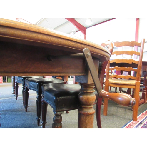 1123 - An oak extending dining table with two extra leaves and winding handle on castors, 72cm tall x 240cm... 