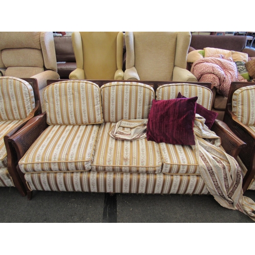 1149 - A 1930's bergere three piece suite consisting of three seater settee and two matching armchairs, str... 