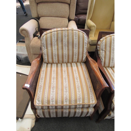 1149 - A 1930's bergere three piece suite consisting of three seater settee and two matching armchairs, str... 