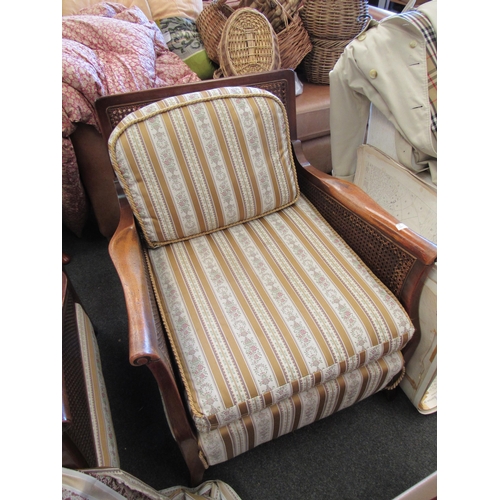 1149 - A 1930's bergere three piece suite consisting of three seater settee and two matching armchairs, str... 