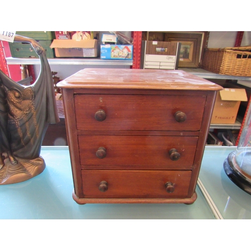 1186 - A miniature chest of three long drawers, 25cm tall x 27cm wide x 21cm deep