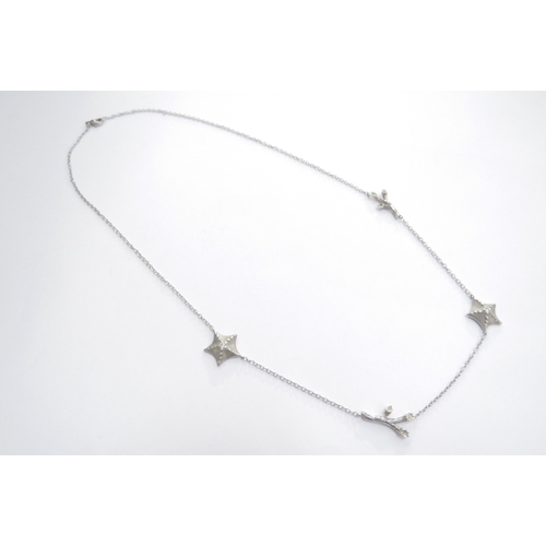 7401 - A Tiffany and Co white gold necklace interspersed with two starfish centrally set with a single diam... 