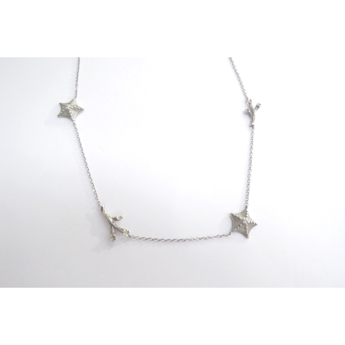 7401 - A Tiffany and Co white gold necklace interspersed with two starfish centrally set with a single diam... 