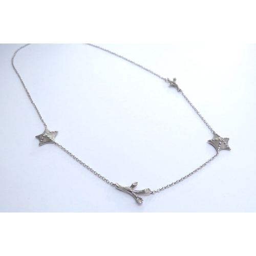 7401 - A Tiffany and Co white gold necklace interspersed with two starfish centrally set with a single diam... 