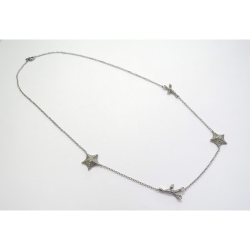 7401 - A Tiffany and Co white gold necklace interspersed with two starfish centrally set with a single diam... 