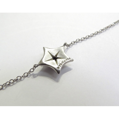 7401 - A Tiffany and Co white gold necklace interspersed with two starfish centrally set with a single diam... 