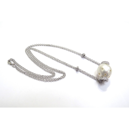 7402 - A white gold double trace chain link necklace with cultured pearl studded with diamonds and diamond ... 