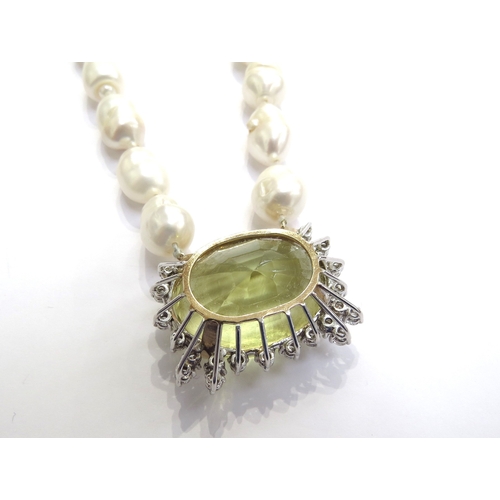 7059 - A single row of baroque shaped freshwater pearls with a large yellow quartz and diamond pendant, qua... 