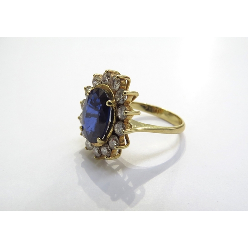 7049 - A sapphire and diamond cluster ring the central oval sapphire 11.5mm x 8.5mm, 3.47ct approx set in f... 