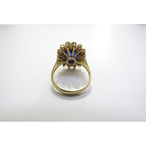 7049 - A sapphire and diamond cluster ring the central oval sapphire 11.5mm x 8.5mm, 3.47ct approx set in f... 