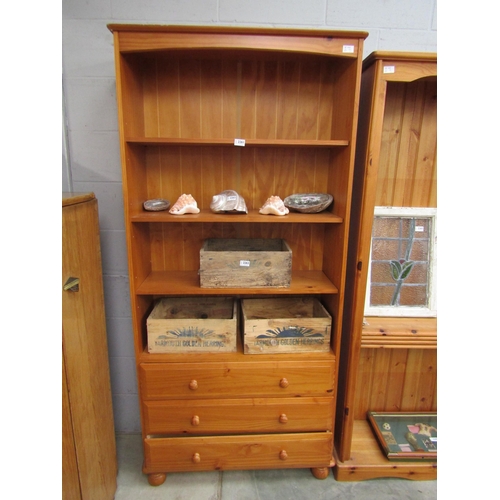 2261 - A pine full height bookcase with three drawer base