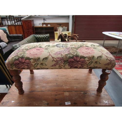 2374 - A foot stool with floral upholstery  top, turned legs