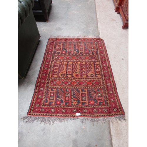 2387 - A middle eastern geometric design wool rug. 116x90cm