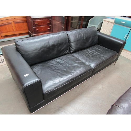 2390 - A black leather and chrome framed sofa